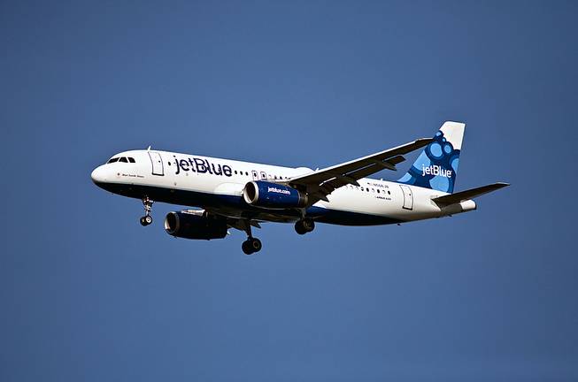 A JetBlue Airbus 320 descends for a landing at Reagan National Airport in Washington, Sunday, June 24, 2012.