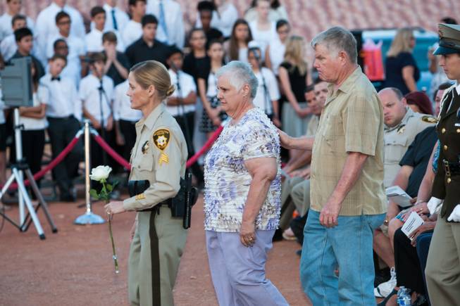 As the names of fallen officers are read, the parents of fallen LVMPD Officer Milburn Beitel approaches the memorial bouquet to pay honor in his memory during the Southern Nevada Law Enforcement Memorial ceremony at Police Memorial Park in Las Vegas Thursday, May 22, 2014.