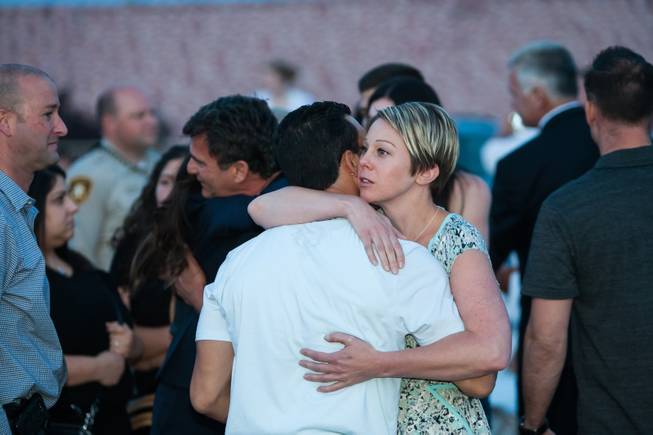 Family members of fallen officer LVMPD Search and Rescue Officer David VanBuskirk are embraced by other attendees during the Southern Nevada Law Enforcement Memorial ceremony at Police Memorial Park in Las Vegas Thursday, May 22, 2014.