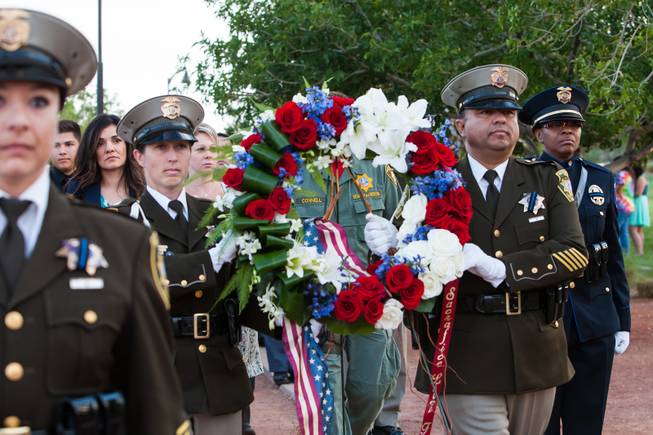 Family members of fallen officer LVMPD Search and Rescue Officer David VanBuskirk follow the memorial wreath during the honor march during the Southern Nevada Law Enforcement Memorial ceremony at Police Memorial Park in Las Vegas Thursday, May 22, 2014.