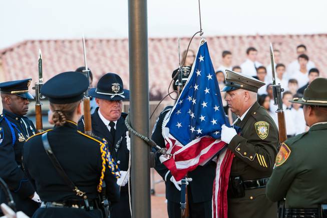 The Nevada Honor Guard raises the American flag to half mast in honor of fallen officers during the Southern Nevada Law Enforcement Memorial ceremony at Police Memorial Park in Las Vegas Thursday, May 22, 2014.