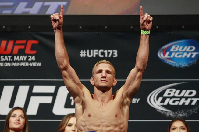 T.J. Dillashaw points after making weight during the weigh in for UFC 173 Friday, May 23, 2014 at the MGM Grand Garden Arena.