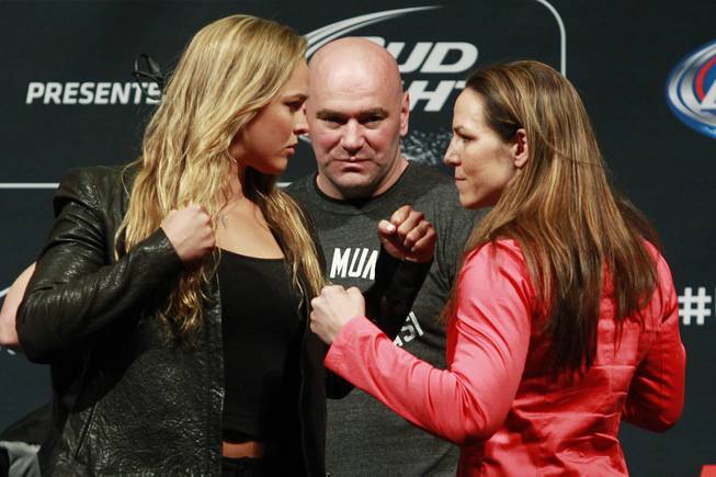 Ronda Rousey, left, and Alexis Davis face off during a news conference to promote UFC 175 on Friday, May 23, 2014, at the MGM Grand Garden Arena. UFC 175 will be July 5, 2014, at the Mandalay Bay Events Center.
