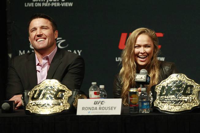 Champions Chael Sonnen and Ronda Rousey laugh during a news conference to promote UFC 175 Friday, May 23, 2014 at the MGM Grand Garden Arena. UFC 175 will be held July 5th, 2014 at the Mandalay Bay Events Center.
