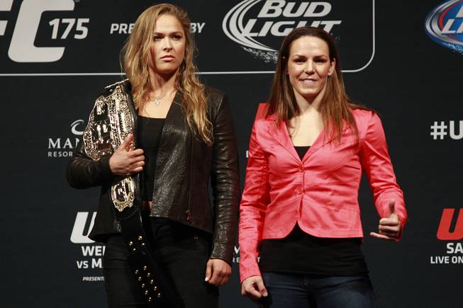 Ronda Rousey, left, and Alexis Davis pose during a news conference to promote UFC 175 Friday, May 23, 2014 at the MGM Grand Garden Arena. UFC 175 will be held July 5th, 2014 at the Mandalay Bay Events Center.