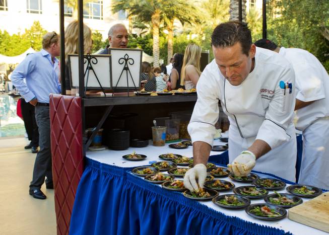Strip House executive chef Dustin Rixey prepares a dish to serve during the Epicurean Affair presented by the Nevada Restaurant Association at the Palazzo on Thursday, May 22, 2014.