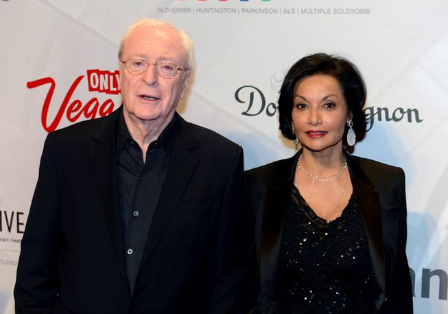 In this photo provided by the Las Vegas News Bureau, Sir Michael Caine  and wife Shakira arrive for the 17th annual Keep Memory Alive Power of Love Gala at MGM Grand Garden Arena in Las Vegas will raise funds for Cleveland Clinic Lou Ruvo Center for Brain Health and its fight against neurodegenerative brain diseases. 