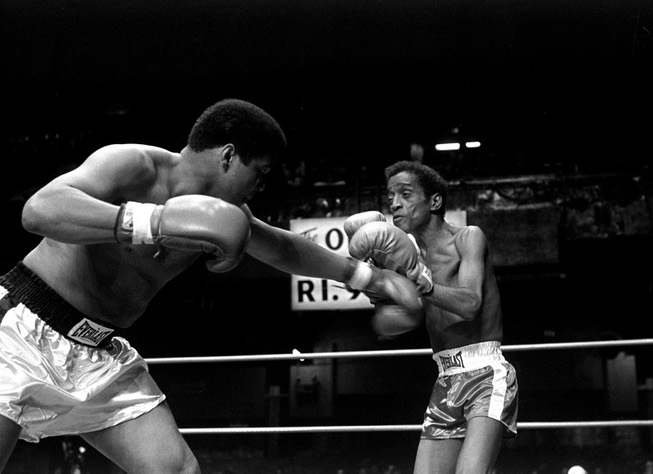 Muhammad Ali is pictured delivering a punch to the body ...