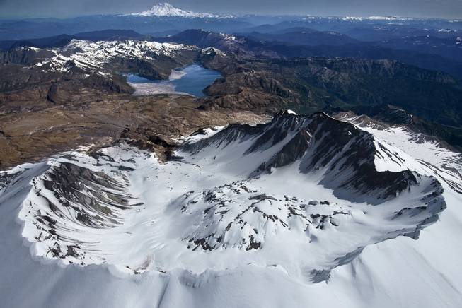 The panoramic and breathtaking view of the south rim of Mount Saint Helens, looking past a still venting lava dome north toward Spirit Lake and Mount Rainier, is awe inspiring but scientist are focused on a repressurizing of the magma chamber below the mountain.