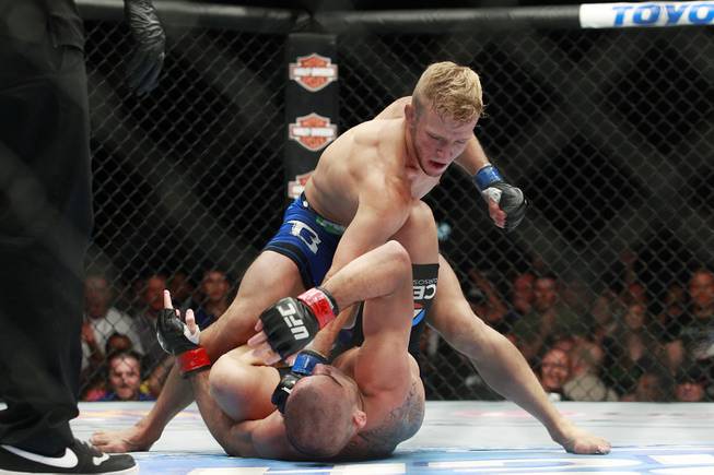 T.J. Dillashaw throws down punches on Renan Barao during their fight at UFC 173 Saturday, May 24, 2014 at the MGM Grand Garden Arena. Dillashaw scored an upset TKO in the fifth round.