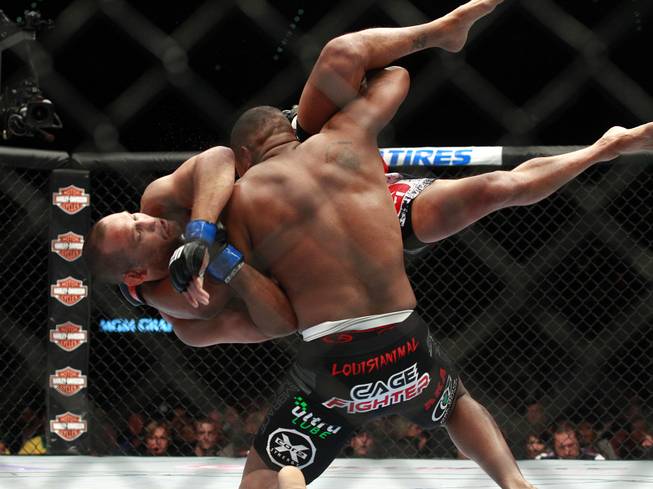 Daniel Cormier throws Dan Henderson during their fight at UFC 173 Saturday, May 24, 2014 at the MGM Grand Garden Arena. Cormier won by submission with a rear naked choke.