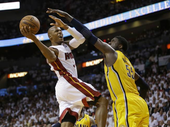 Miami Heat guard Ray Allen drives to the basket over Indiana Pacers center Roy Hibbert during the second half of Game 3 in the NBA basketball Eastern Conference finals playoff series Saturday, May 24, 2014, in Miami.