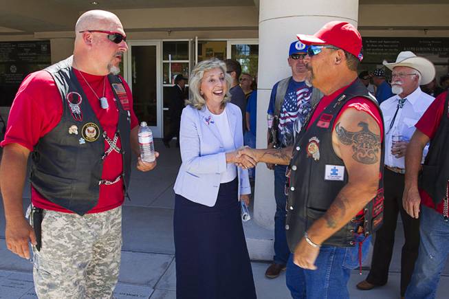 Congresswoman Dina Titus talks with members of Red Riderz, a local charity, during a Memorial Day ceremony at the Southern Nevada Veterans Memorial Cemetery in Boulder City Monday, May 26, 2014.
