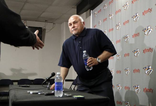 In this April 14, 2014, file photo, Nashville Predators coach Barry Trotz leaves a news conference in Nashville, Tenn. The Washington Capitals have promoted Brian MacLellan to general manager and hired former Predators coach Trotz. The team announced the moves Monday, May 26, 2014.