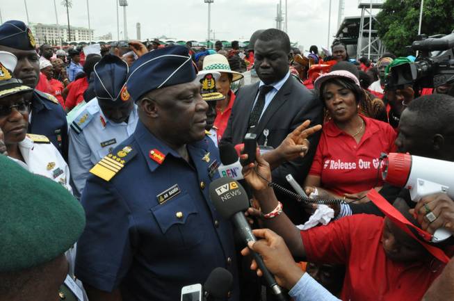 Nigeria's chief of defense staff Air Marshal Alex Badeh, centre, speaks during a demonstration calling on the government to rescue the kidnapped girls of the government secondary school in Chibok, in Abuja, Nigeria, Monday, May 26, 2014. Scores of protesters chanting "Bring Back Our Girls" marched in the Nigerian capital Monday to protest the abductions of more than 300 schoolgirls by Boko Haram, the government's failure to rescue them and the killings of scores of teachers by Islamic extremists in recent years.