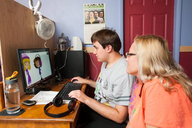 Author Ben Nelson, 20, who is autistic and has recently published his first book "Little Red Flying Hood," works alongside his mom as he creates a new comic book while working at his home in Henderson May 23, 2014.
