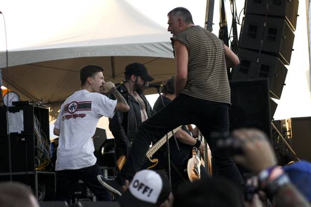 The Dwarves invite a fan to sing on stage during their set at the Punk Rock Bowling & Music Festival Sunday, May 25, 2014.