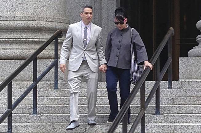 The Beastie Boys rapper Adam "Ad-Rock" Horovitz leaves federal court in Manhattan on Tuesday, May 27, 2014, in New York with his wife Kathleen Hanna after testifying at a copyright trial stemming from a lawsuit his musical group brought against a beverage maker over the use of five of their songs in a video.