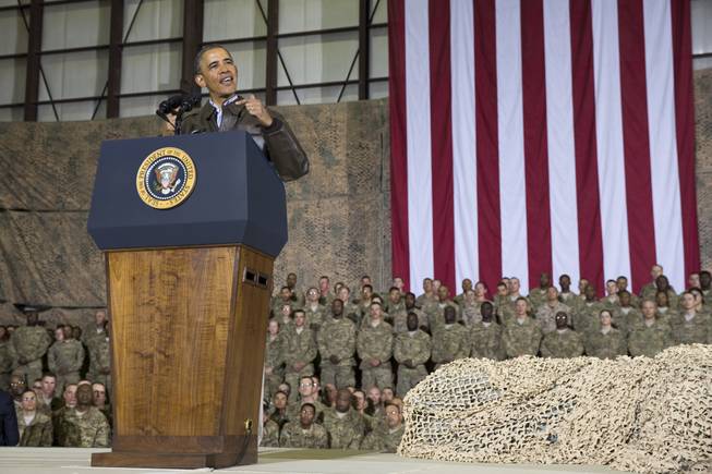 This May 25, 2014, file photo shows President Barack Obama speaking during a troop rally after arriving at Bagram Air Field for an unannounced visit, north of Kabul, Afghanistan. Senior U.S. administration officials say  Obama will seek to keep 9,800 U.S. troops in Afghanistan after the war formally ends later this year. Nearly all of those forces are to be out by the end of 2016, as Obama finishes his second term.