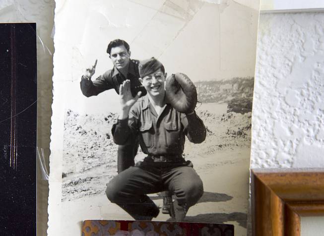 A 1944 photo of World War II veteran Gaetano "Guy" Benza, left, and friend Bernie Donitz, is displayed in Benza's home in North Las Vegas Wednesday, May 28, 2014. Benza and Davis Leonard, another local World War II veteran, will receive the French Legion d'Honneur award on Friday. The award is the highest honor France bestows on its citizens and foreign nationals. A