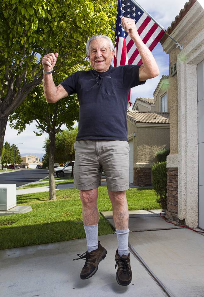 World War II veteran Gaetano "Guy" Benza jumps as he shows off his physical fitness outside his home in North Las Vegas Wednesday, May 28, 2014. Benza and Davis Leonard, another local World War II veteran, will receive the French Legion d'Honneur award on Friday. The award is the highest honor France bestows on its citizens and foreign nationals.