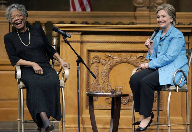 In this April 18, 2008 file photo, then U.S. Sen. Hillary Rodham Clinton, D-N.Y., right, speaks as poet Maya Angelou reacts during a campaign stop at Wake Forest University in Winston-Salem, N.C. 