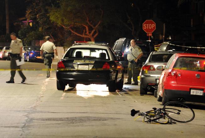 In this image provided by the Santa Barbara Independent, police investigate the scene after a mass shooting near the campus of the University of Santa Barbara in Isla Vista, Calif., Friday, May 23, 2014. 