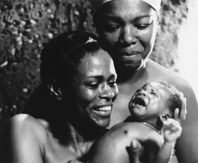 This is a scene from ABC's 1977 miniseries "Roots" with actress Cicely Tyson with baby; and Maya Angelou in background. Angelou received an Emmy nomination for her role as Nyo Bobo in Alex Haley's television miniseries. 