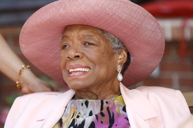 In this May 20, 2010, file photo, author Maya Angelou socializes during a garden party at her home in Winston-Salem, N.C. Angelou, author of "I Know Why the Caged Bird Sings," has died, Wake Forest University said Wednesday, May 28, 2014. She was 86.