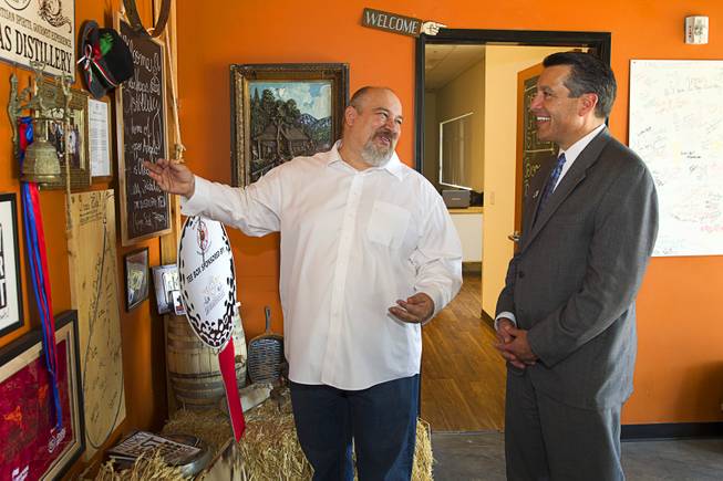 Distillery owner George Racz, left, gives a tour to Nevada Governor Brian Sandoval at the Las Vegas Distillery in Henderson Thursday, May 29, 2014. Governor Sandoval helped fill the first bottle of "Nevada 150," a bourbon whiskey created for the Nevada sesquicentennial.