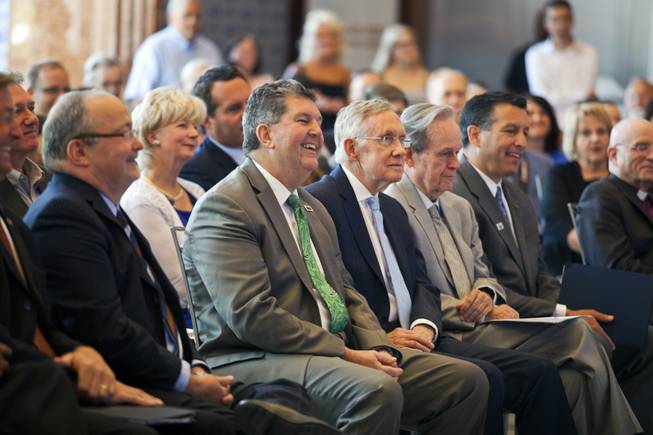 Dignitaries laugh during the unveiling ceremony of the Nevada Sesquicentennial commemorative stamp at the Smith Center on Thursday, May 29, 2014.