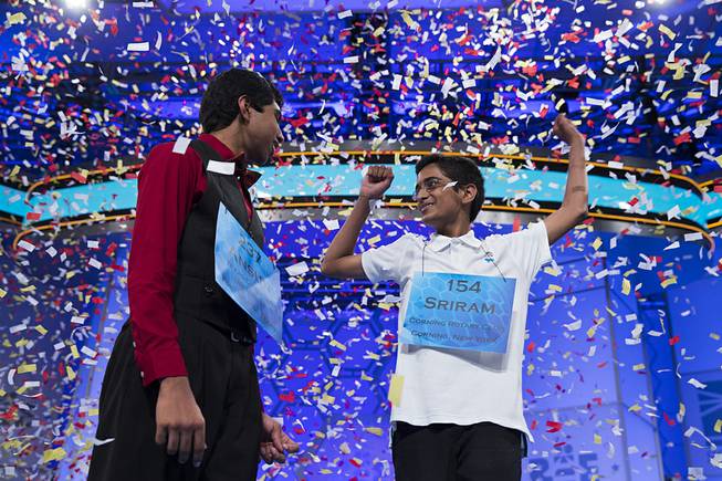 Ansun Sujoe, 13, of Fort Worth, Texas, left, and Sriram Hathwar, 14, of Painted Post, N.Y., celebrate after being named co-champions of the National Spelling Bee, on Thursday, May 29, 2014, in Oxon Hill, Md.