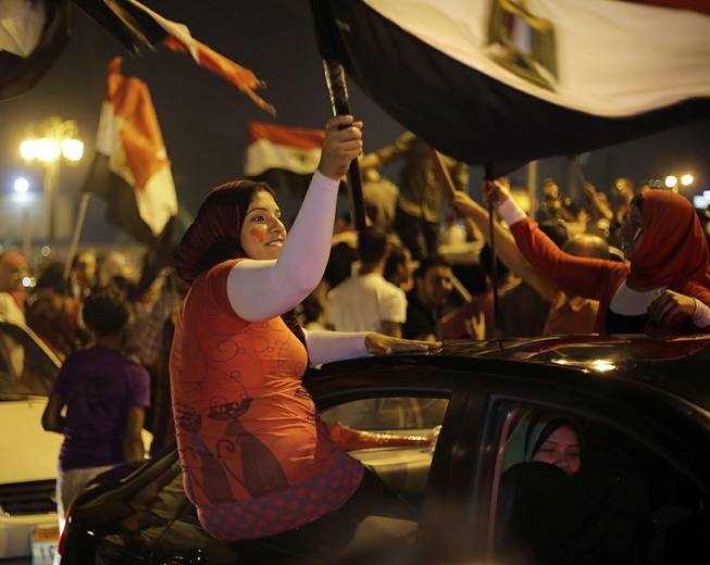 Supporters of presidential hopeful Abdel-Fattah el-Sissi, Egypt's former military chief, wave national flags during a celebration at Tahrir Square in Cairo, Egypt, Thursday, May 29, 2014. El-Sissi appeared well on his way to a landslide victory over his sole opponent, according to partial election results announced late Wednesday, after voting was extended for a third day in an attempt to prevent an embarrassment over low turnout. 