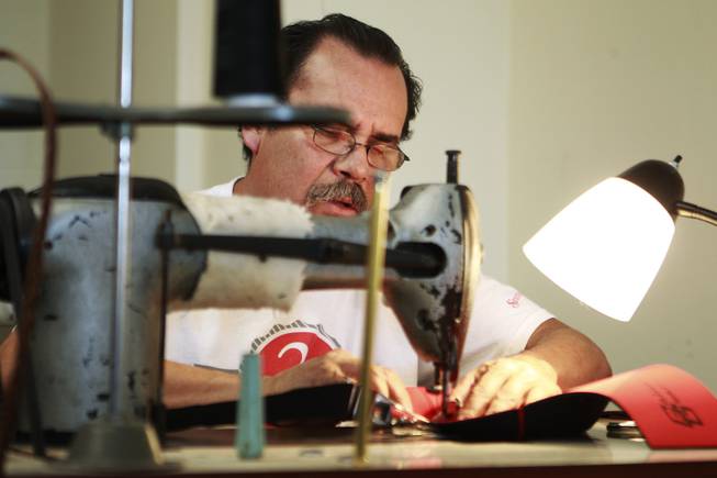 Guadalupe Calderon works on a sewing machine at the Dapper Factory Friday, May 23, 2014.