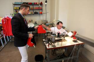 Guadalupe Calderon hands a sample to Derek Smoot at the Dapper Factory Friday, May 23, 2014.