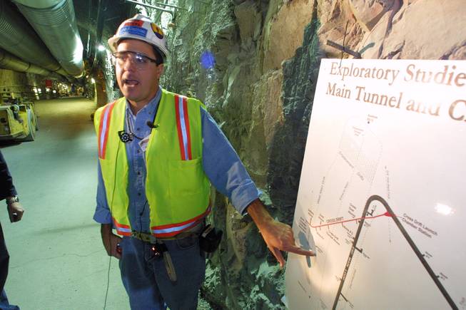 Mark Peters from the Yucca Mountain Project describes different areas of the drift scale test tunnel to members of the media during a public open house Saturday, November 3, 2001. The tunnel and surrounding rock has been heated to an average 392 degrees for the past four years and then will be allowed to cool beginning January 2002 for another four years to study the effect on the movement of water through Yucca Mountain.