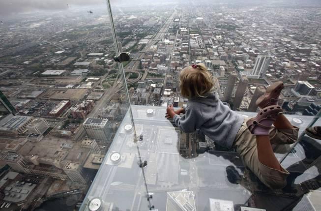  This June 24, 2009 file photo shows Anna Kane, 5, looking down from the "The Ledge," at Chicago's Willis Tower. 