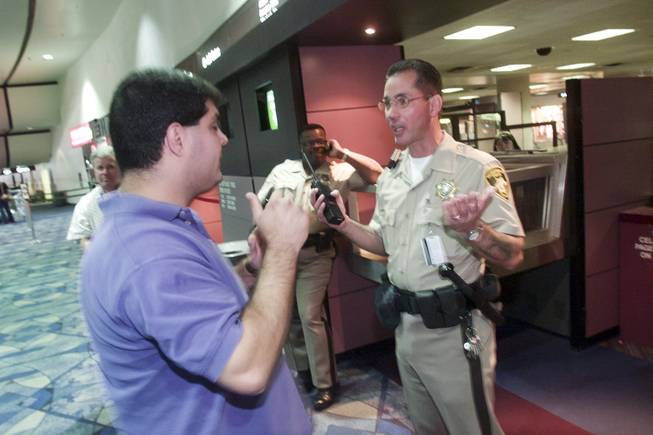 A man is denied passage to the gate area by Metro Police officer Frank Mandracchio at McCarran International Airport Tuesday, Sept. 11, 2001.