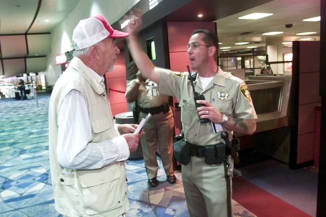 A man trying to locate his wife is denied passage to the gate area by Metro officer Frank Mandracchio at McCarran International Airport Tuesday, Sept. 11, 2001.