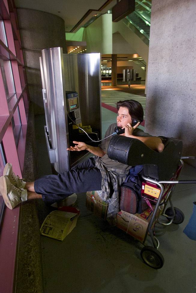 A woman stranded at McCarran International Airport makes a phone call to relatives Tuesday, Sept. 11, 2001.
