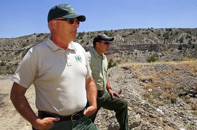 Randy Swick, left, Spring Mountains National Recreation Area manager, and Ron Bollier, a U.S. Forest Service fire management officer, look over an area near Harris Springs Road and Kyle Canyon Road on Mt. Charleston Tuesday, May 27, 2014. The mountain is showing signs of recovery, about one year after the Carpenter 1 Fire that scorched almost 28,000 acres in 2013.