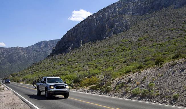 Traffic passes by the site of the Robbers Fire, right, a fire that burned about 10 years ago, on Mt. Charleston Tuesday, May 27, 2014.