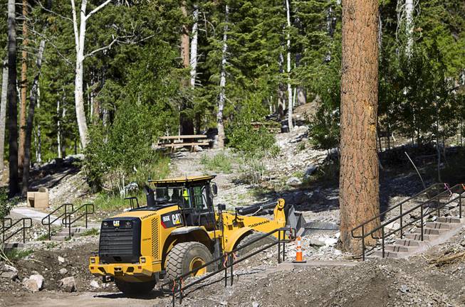 A worker makes improvements to a drainage area at the Cathedral Rock Picnic Area on Mt. Charleston Tuesday, May 27, 2014. The area was damaged by flood run-off and debris following the Carpenter 1 Fire that scorched almost 28,000 acres in 2013.