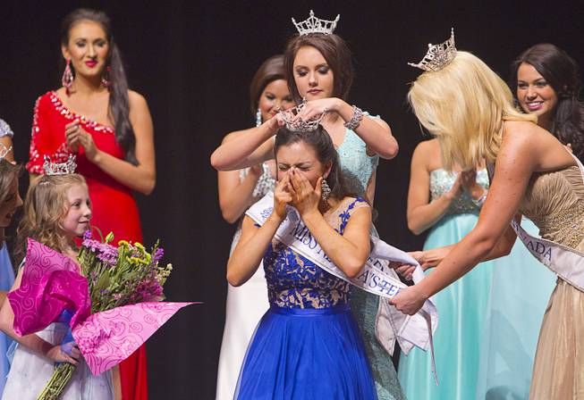 Amy Smith of Henderson as she is crowned 2014 Nevada Outstanding Teen by Katarina Clark at the Miss Nevada and Miss Nevada Outstanding Teen Pageant at the Las Vegas Academy Theater Sunday, June 1, 2014. Amy's sister Ellie Smith later was crowned 2014 Miss Nevada.