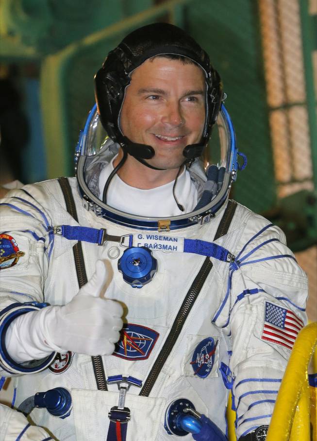 NASA astronaut Reid Wiseman, crew member of the mission to the International Space Station, ISS, gestures prior the launch of Soyuz-FG rocket at the Russian leased Baikonur cosmodrome, Kazakhstan, on Wednesday, May 28, 2014.