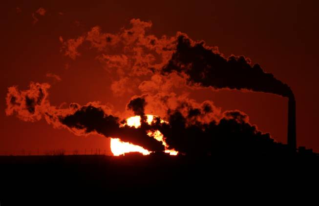 In this March 8, 2014, file photo steam from the Jeffrey Energy Center coal-fired power plant is silhouetted against the setting sun near St. Marys, Kan. As President Barack Obama prepares to announce tougher new air quality standards affecting coal-fired power plants, lawmakers in about a half-dozen state already have acted pre-emptively. Not to toughen their own standards, but to make it tougher to enforce the new federal ones.