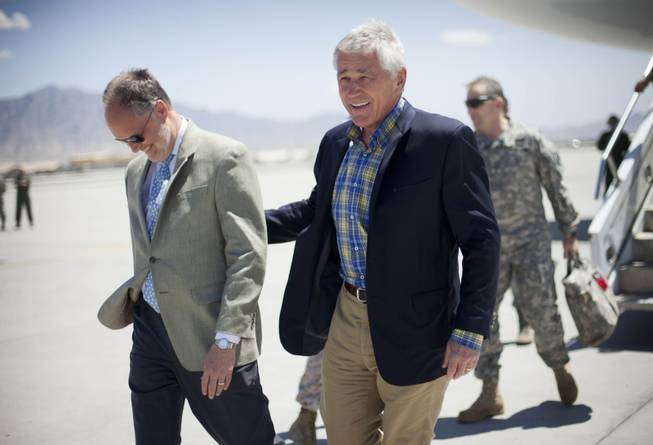 U.S. Defense Secretary Chuck Hagel, right, walks on the tarmac with U.S. Ambassador to Afghanistan James Cunningham, left, during his arrival to Bagram Airfield in Afghanistan, Sunday, June 1, 2014.