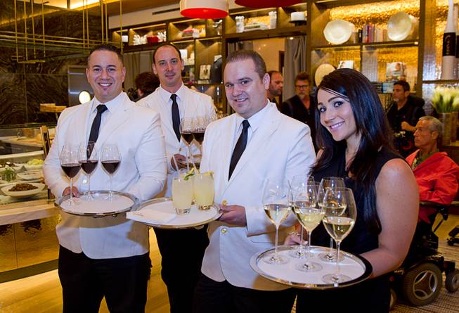 Servers greet guests with wine and fresh basil lemonade during the VIP grand opening of Giada, the first Giada De Laurentiis restaurant, on Monday, June 2, 2014, in the Cromwell. 