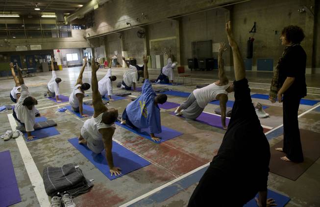 Yoga instructor, Iwona, right, and Zack Pasillas, outreach director with the Yoga Seed Collective, teach a weekly yoga class inside the California State Prison in Sacramento, Calif., on April 30, 2014.