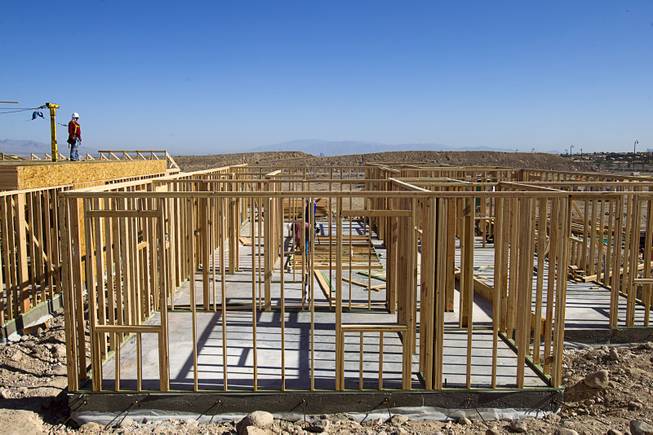 Capenters work on a KB Homes project at Inspirada in Henderson Tuesday, June 3, 2014. A number of formerly stalled or financially troubled master-planned communities are now back in business, with developers building and selling homes.